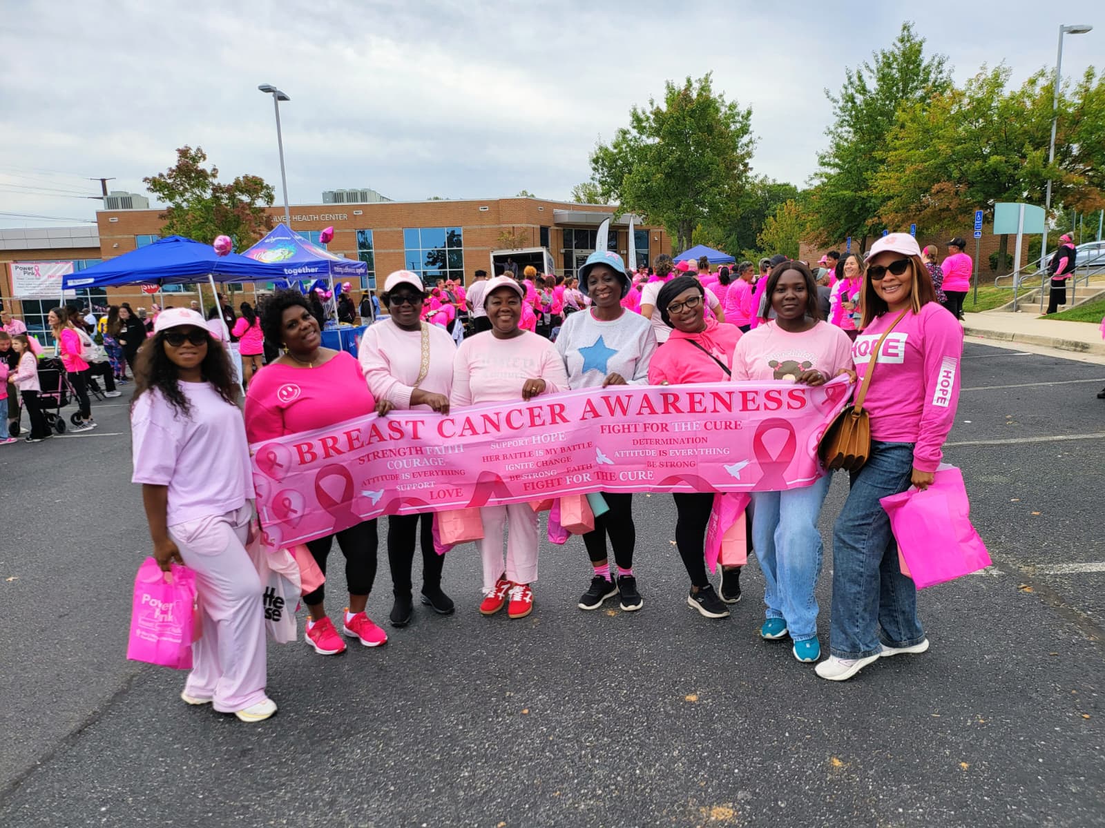 Church group gathered with a breast cancer awareness banner
